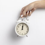 front view hand held clock with copy space